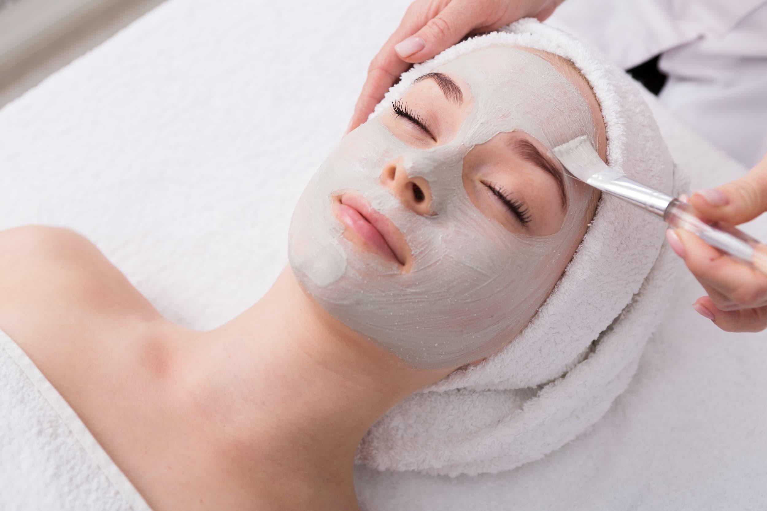 A woman reciving a bridal facial before a wedding in a med spa to prepare for wedding makeup.