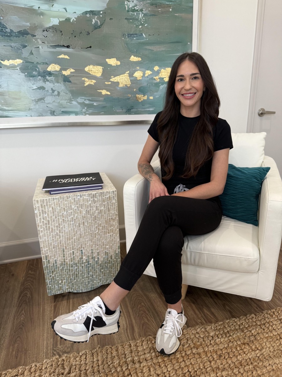 Coastal Health & Medical Spa interior in Jacksonville, FL — Danielle seated in the treatment lounge
