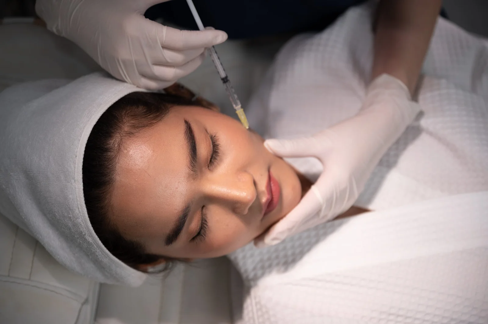 A woman receiving a Sculptra cheek injection at Coastal Health & Medical Spa in Jacksonville, FL to rebuild collagen and restore mid-face volume