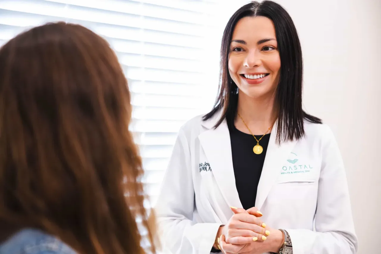 Dr. Olivia Jose reviewing blood test results and a personalized supplement plan with a patient in Jacksonville, FL