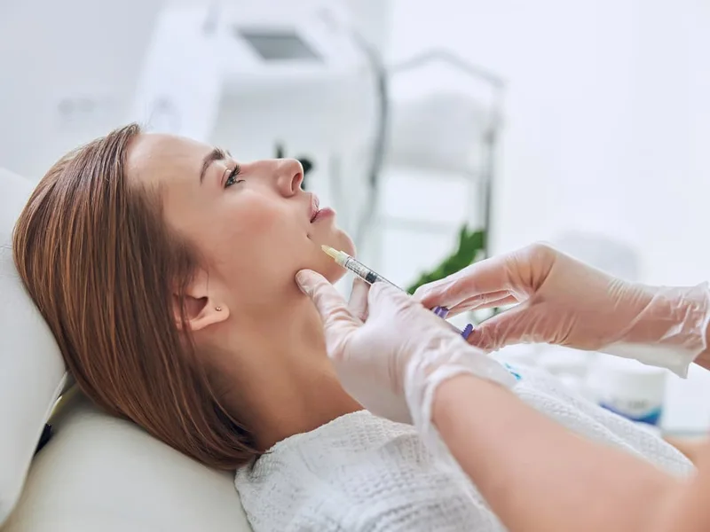 Provider injecting dermal filler into a patient's cheek during a cheek filler treatment at Coastal Health & Medical Spa in Jacksonville, FL