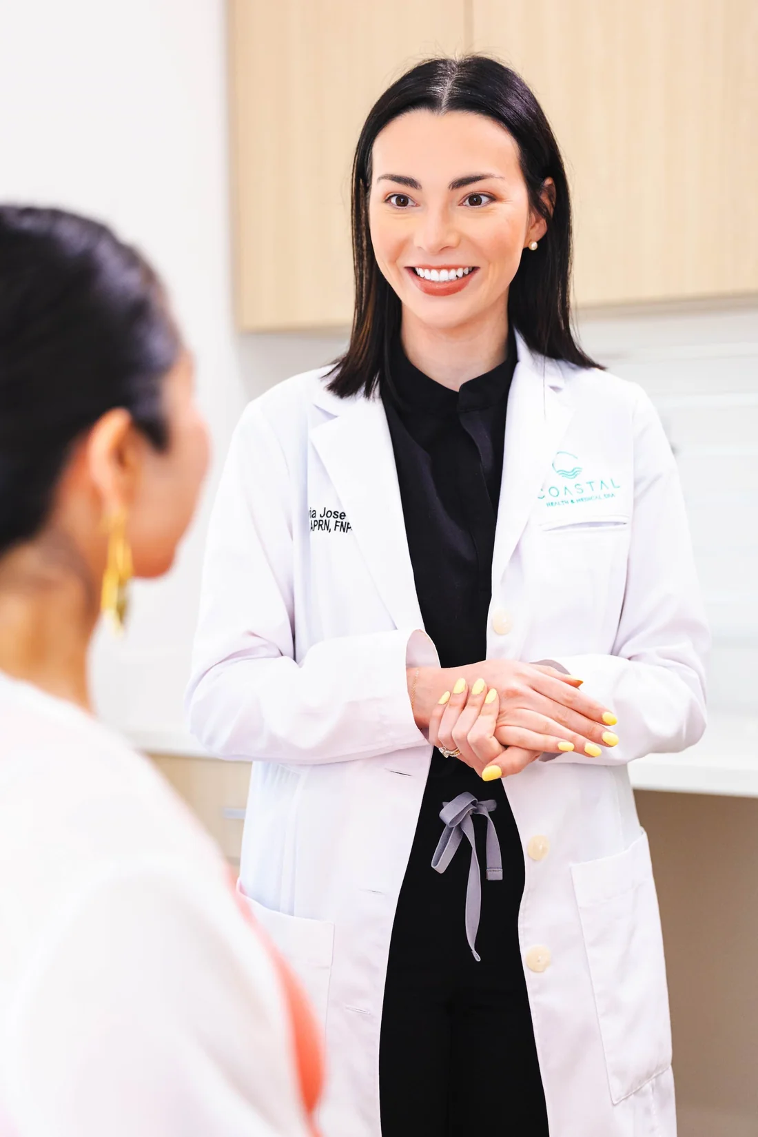 Dr. Olivia Jose standing with a patient during a full-face jawline filler evaluation at Coastal Health & Medical Spa in Jacksonville, FL