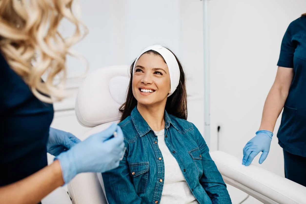 A smiling patient in the treatment chair after a jawline filler appointment at Coastal Health & Medical Spa in Jacksonville, FL