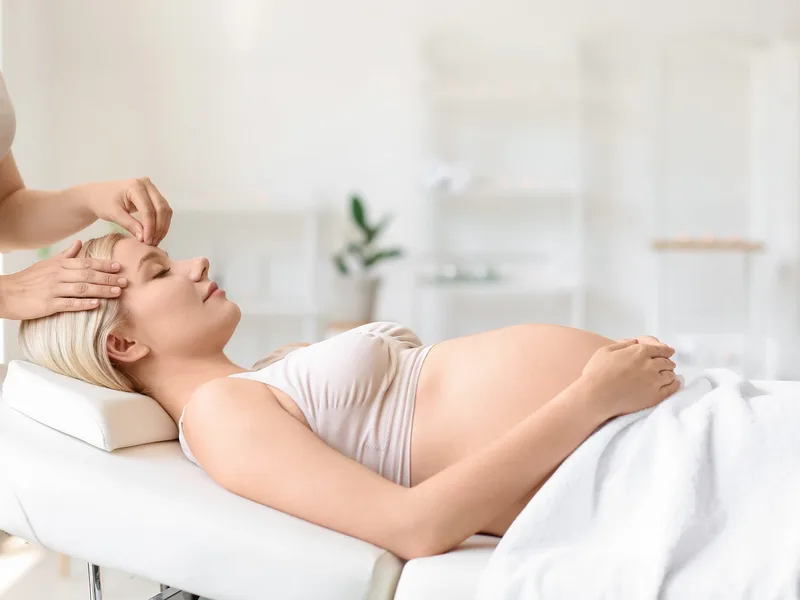 Expecting mother relaxing during a pregnancy-safe Mama Glow facial in Jacksonville