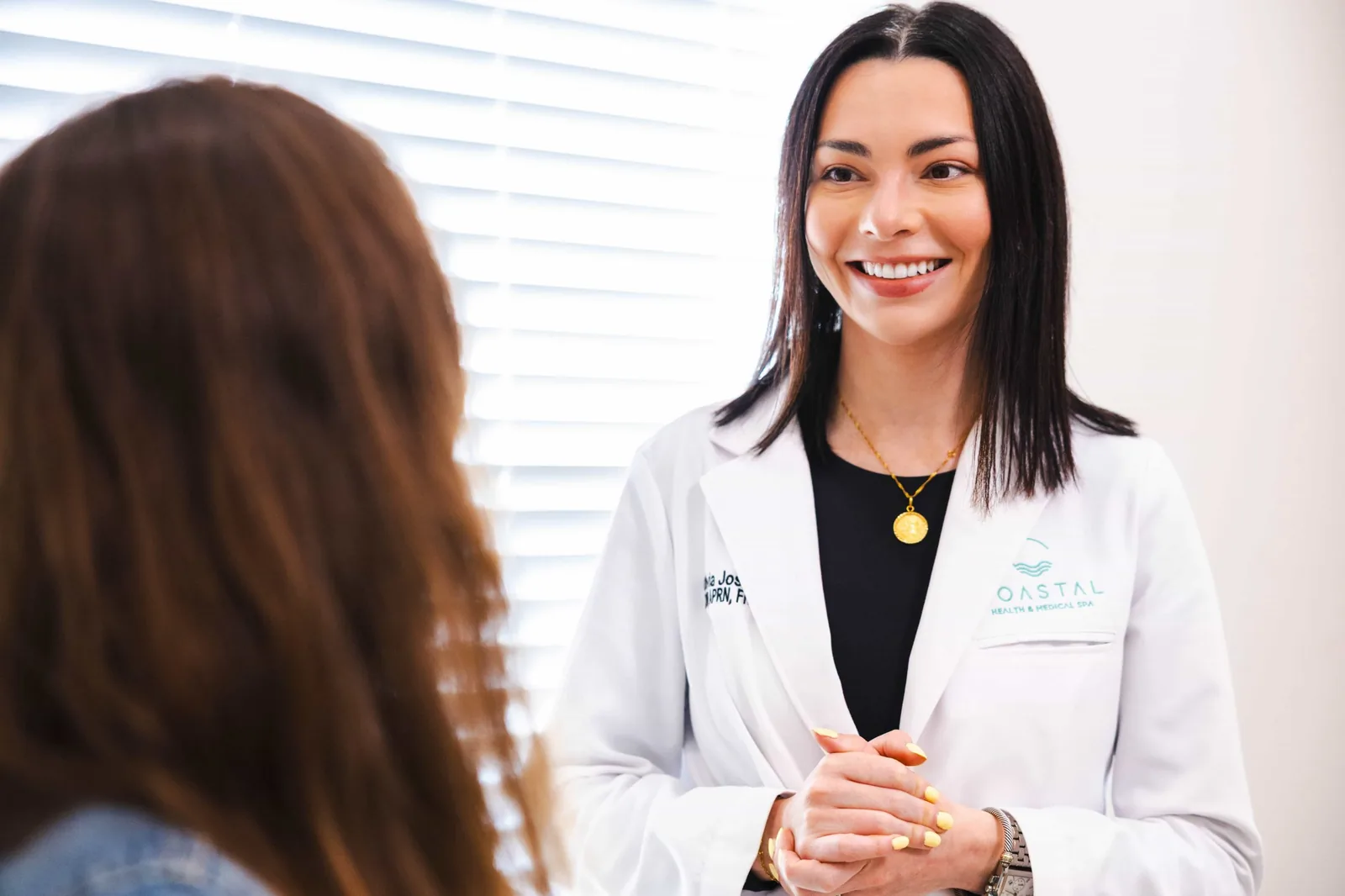 Patient at a maintenance consultation with her provider at Coastal Health & Medical Spa in Jacksonville to keep her nasolabial fold filler results continuous