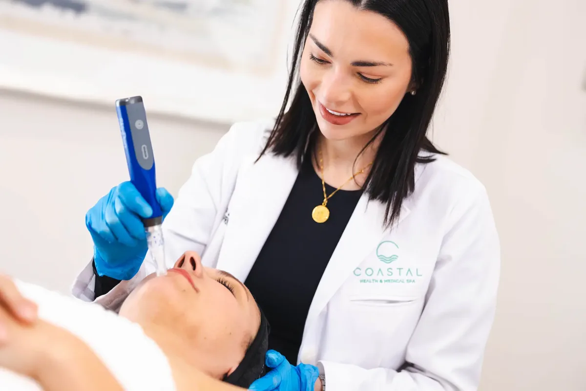 A Coastal Health & Medical Spa provider performing SkinPen microneedling on a patient in Jacksonville, FL, before walking her through aftercare.
