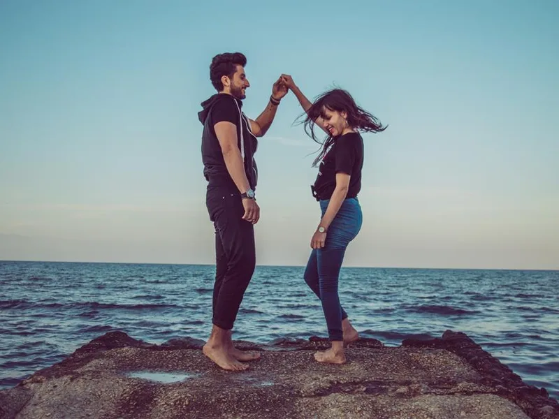 Happy couple dancing together by the water, representing women's sexual health and wellness care in Jacksonville, FL