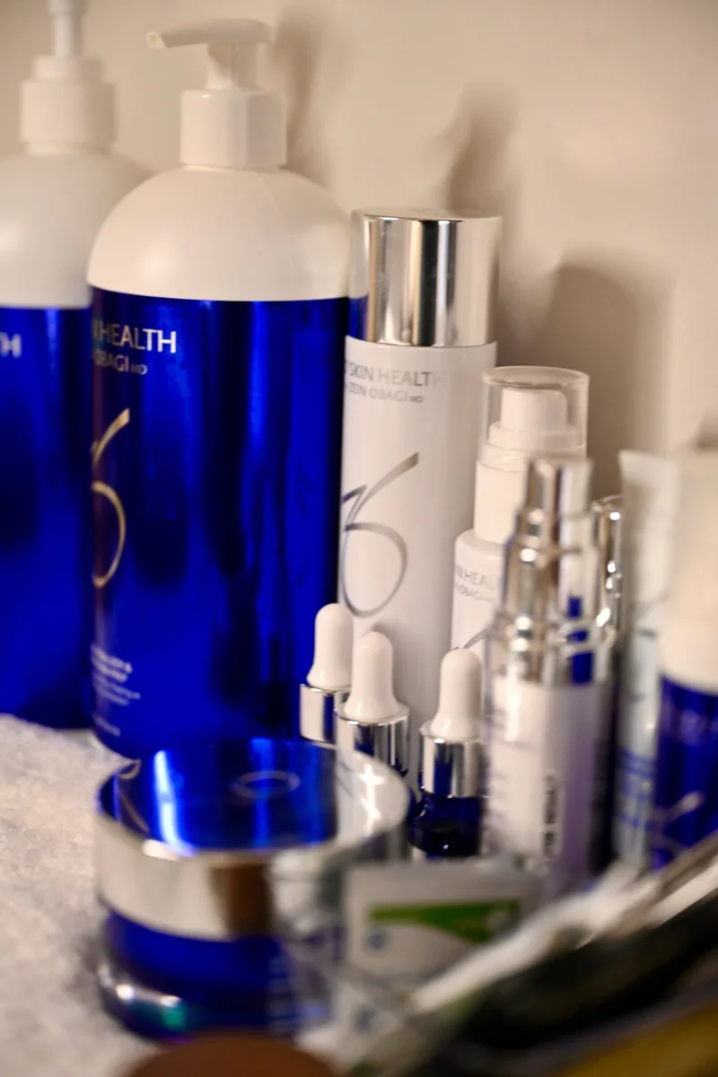ZO Skin Health product shelf in the aesthetics studio at Coastal Health & Medical Spa, the brand behind the ZO Stimulator Peel and ZO Brightalive serum used in the brightening facial.