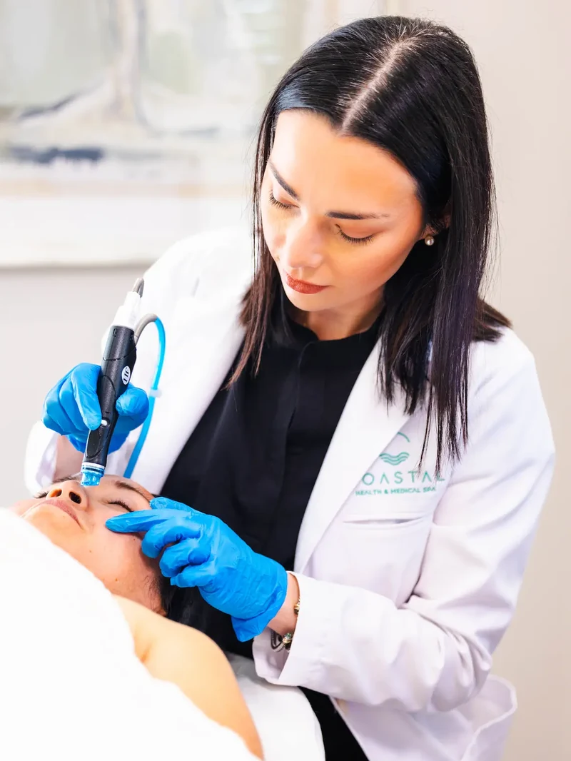 Dr. Olivia, DNP, APRN, performing a HydraFacial treatment at Coastal Health & Medical Spa in Jacksonville, FL