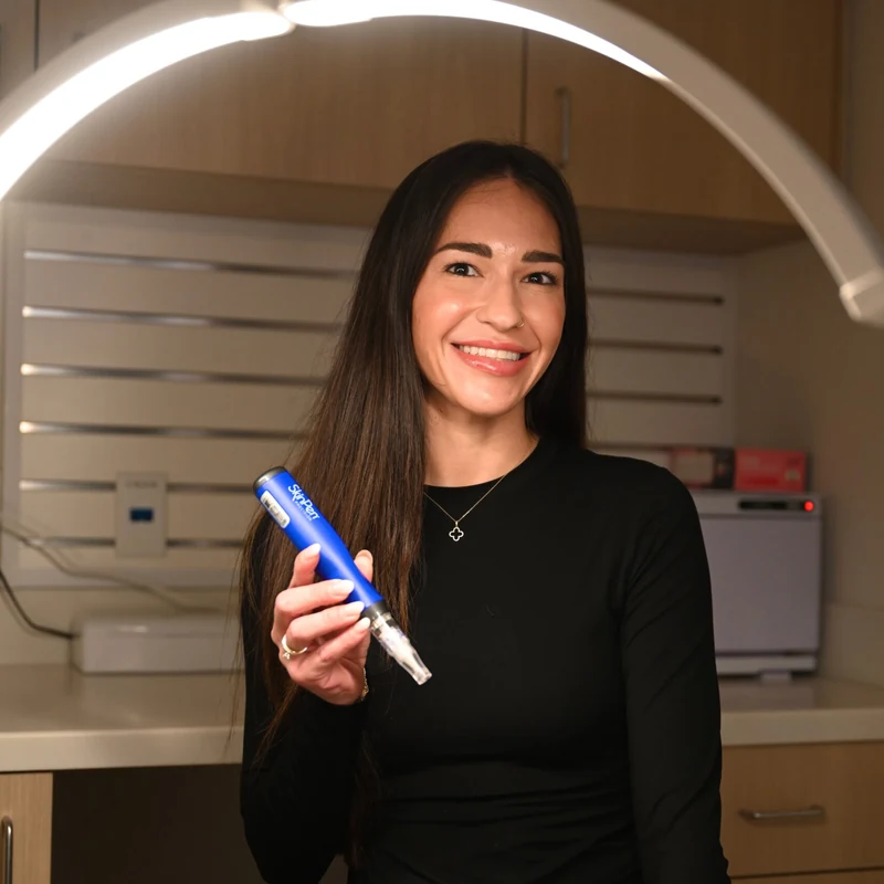 Danielle Hancock holding the microneedling pen used for the HydraPen add-on to a men's facial at Coastal Health & Medical Spa in Jacksonville