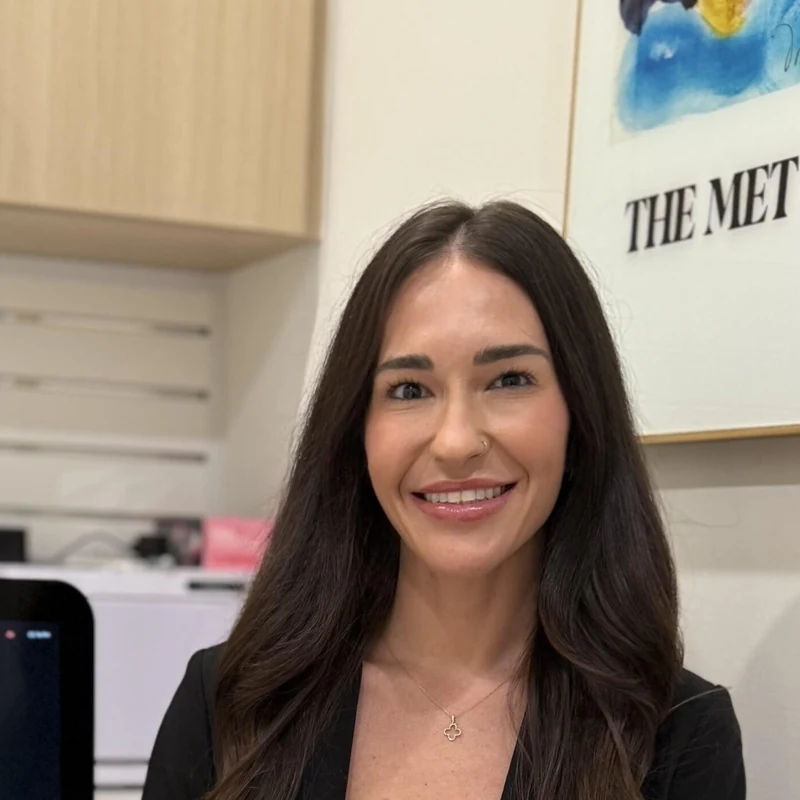 Danielle Hancock, Licensed Aesthetician, seated beside the HydraFacial platform where every men's facial at Coastal Health & Medical Spa in Jacksonville begins with a skin analysis