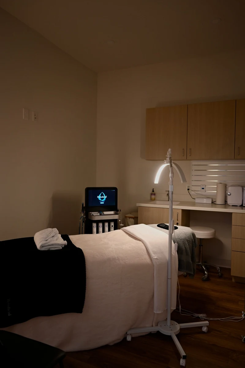 The private facial suite at Coastal Health & Medical Spa in Jacksonville, with the treatment bed, LED arch lamp, and HydraFacial platform used for men's facials