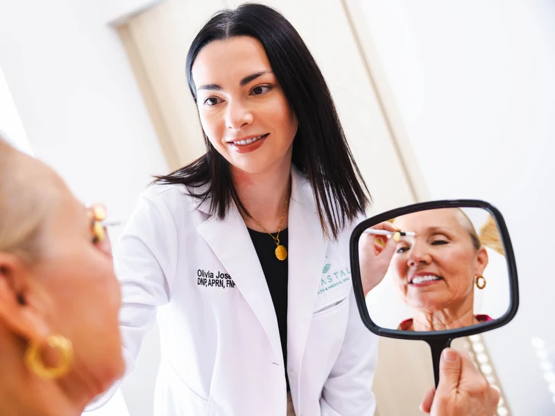 Nose filler in Jacksonville: Dr. Olivia, DNP, APRN, checking a patient's profile in a hand mirror at Coastal Health & Medical Spa