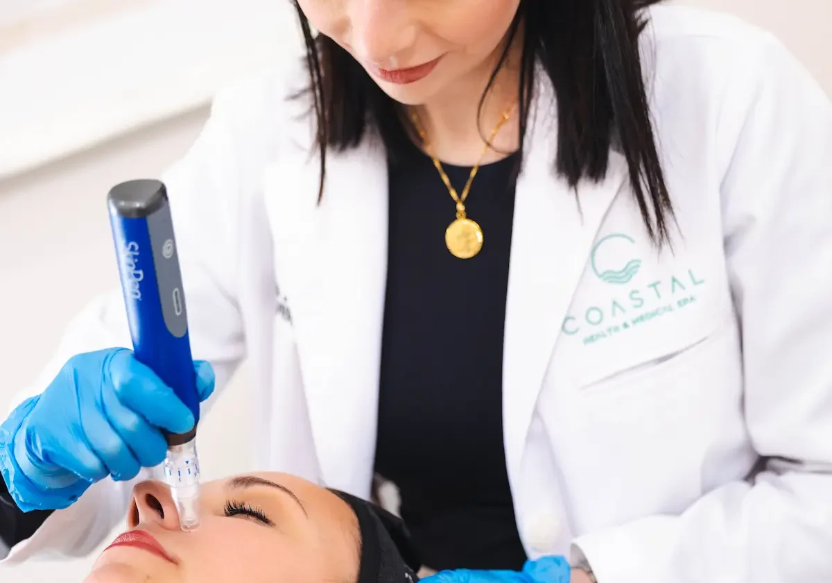 A practitioner performing Skinpen Microneedling on a young woman patient