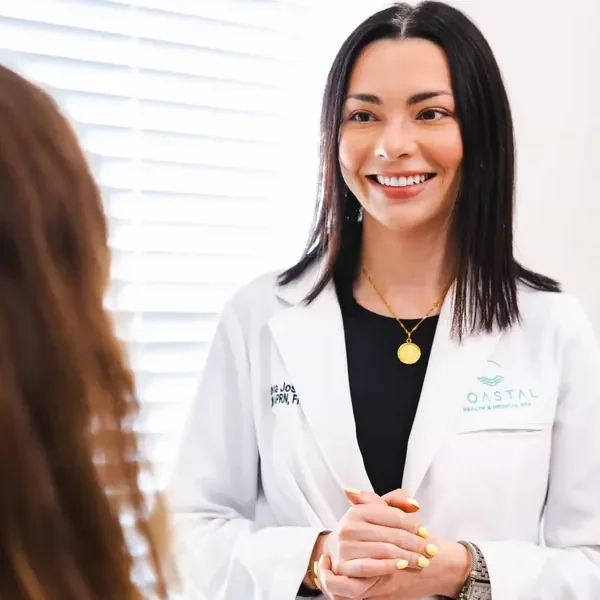 Dr. Olivia Jose, DNP, APRN, consulting with a patient about nasolabial fold filler at Coastal Health & Medical Spa in Jacksonville, FL