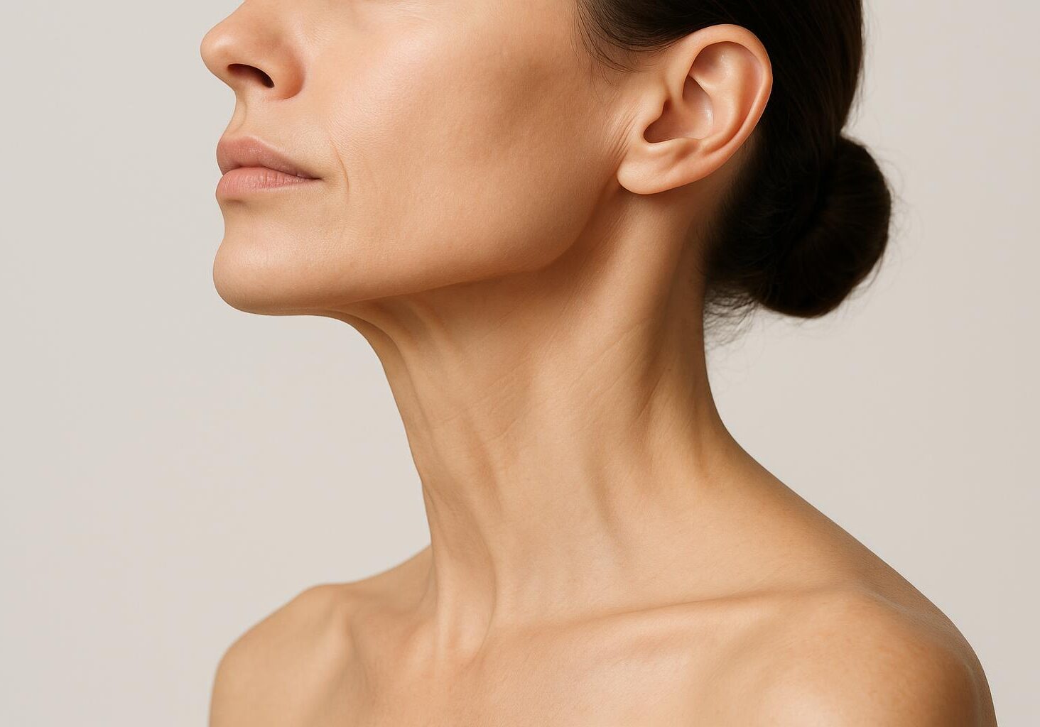 Profile view of a woman's neck showing prominent platysmal bands, a key area for a Botox 'Nefertiti Lift' to create a more defined jawline