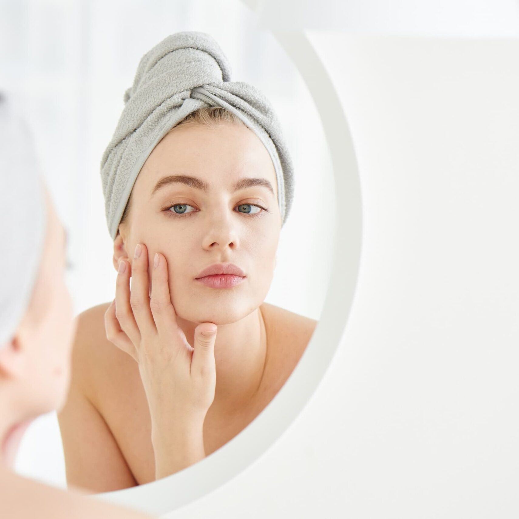 woman applying skincare routine for microneedling