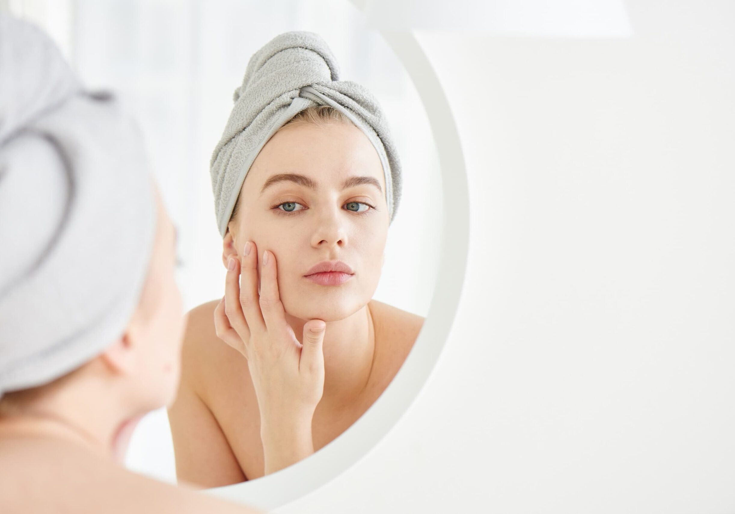 woman applying skincare routine for microneedling